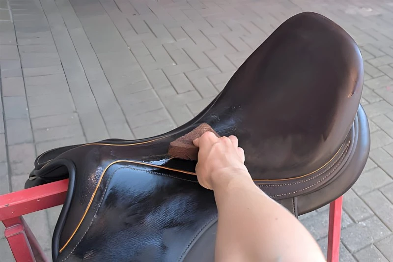horse saddle cleaning activity showcasing care and maintenance techniques in a stable horse saddle cleaning activity showcasing care and maintenance techniques in a stable